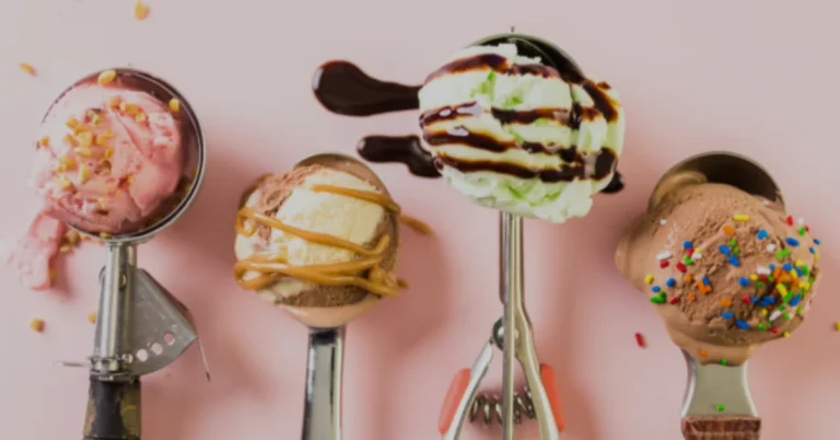 Ice cream scoop holding colorful, decorated ice cream scoops with toppings on a pink background.